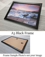 Load image into Gallery viewer, Vibrant Seaside Sunset: Framed Coastal Artwork with Weathered Wooden Ruins Above Serene Seashore - Print Store