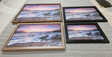 Load image into Gallery viewer, Vibrant Seaside Sunset: Framed Coastal Artwork with Weathered Wooden Ruins Above Serene Seashore - Print Store
